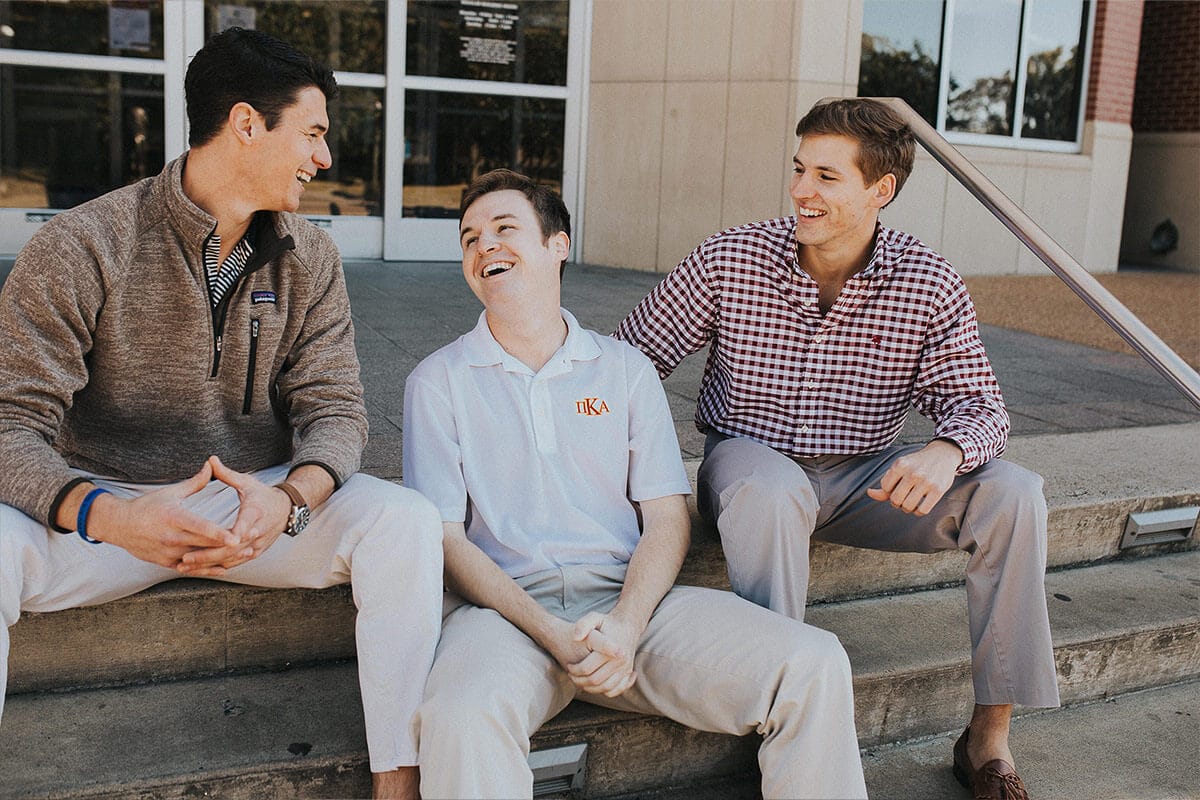 PIKE members sitting on steps and laughing