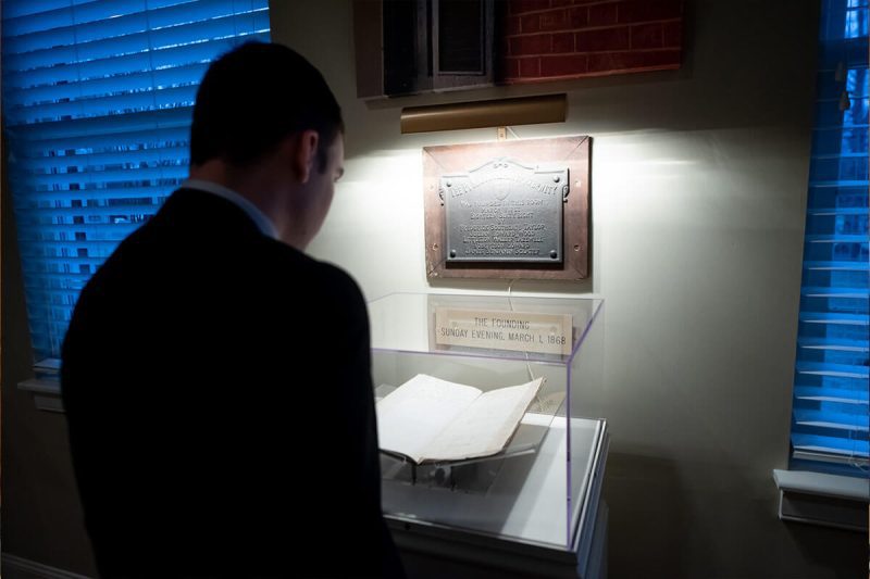 a PIKE member looking at historical document