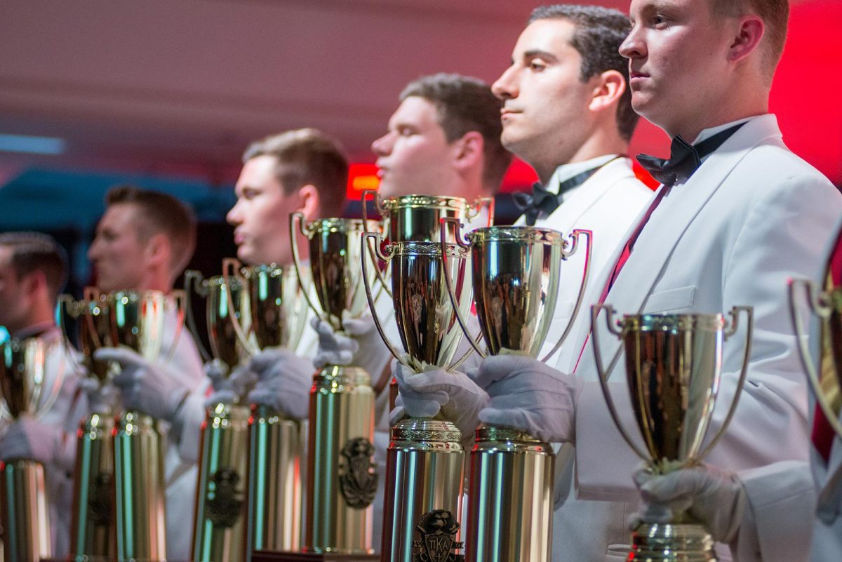 a group of members holding awards